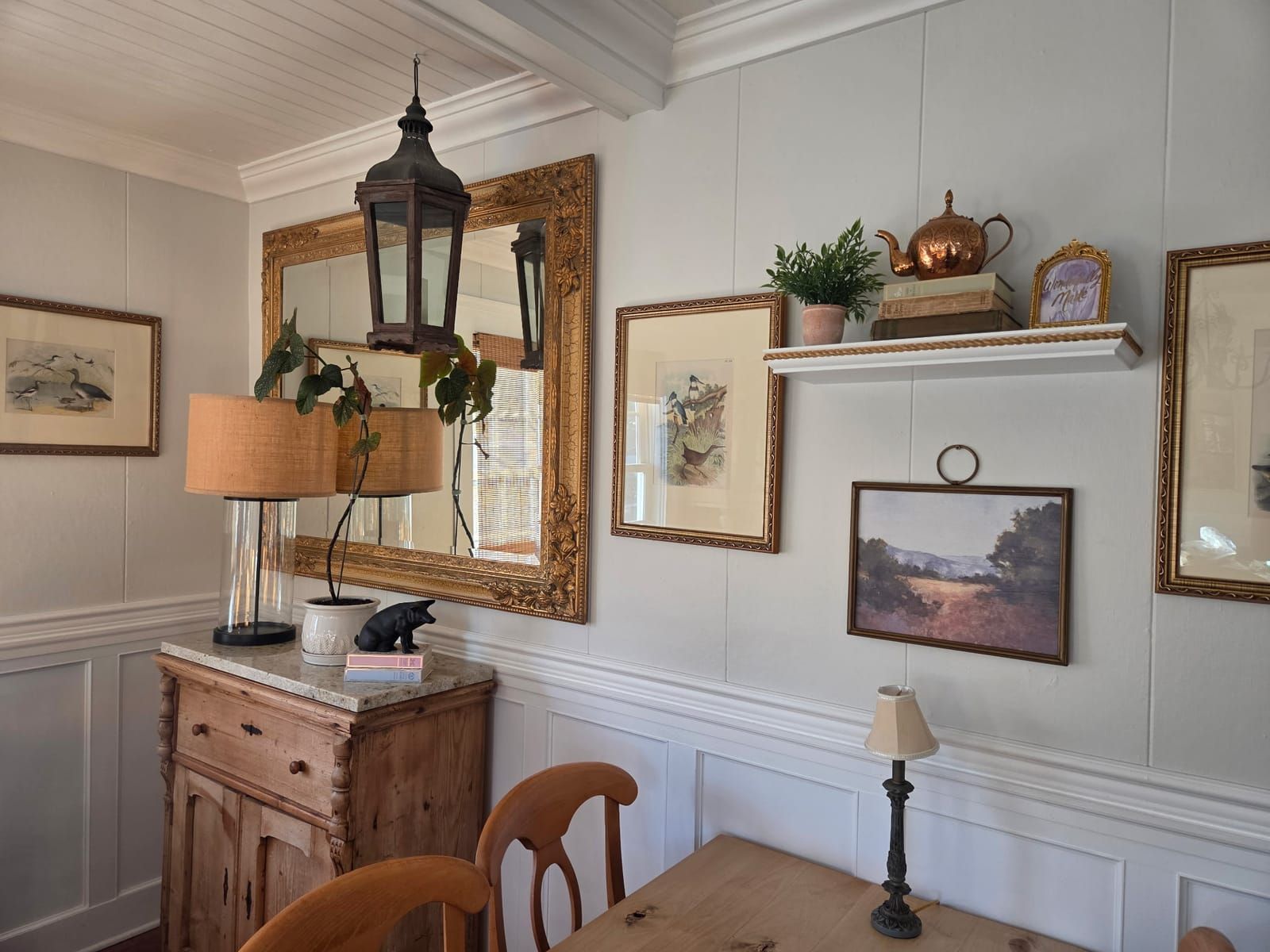 A corner of the dining room with a gallery wall